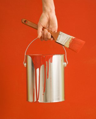 Woman holding paint can. clipart