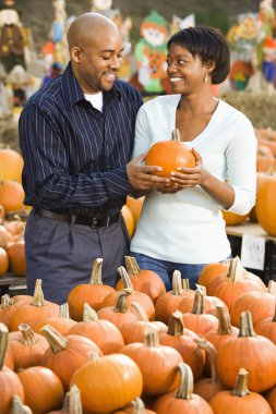 Couple buying pumpkin. clipart