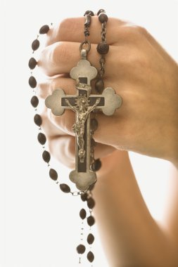 Woman holding crucifix. clipart