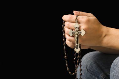 Woman holding rosary.