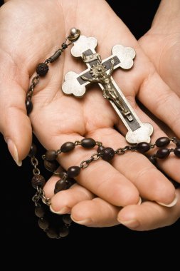 Hands holding rosary. clipart
