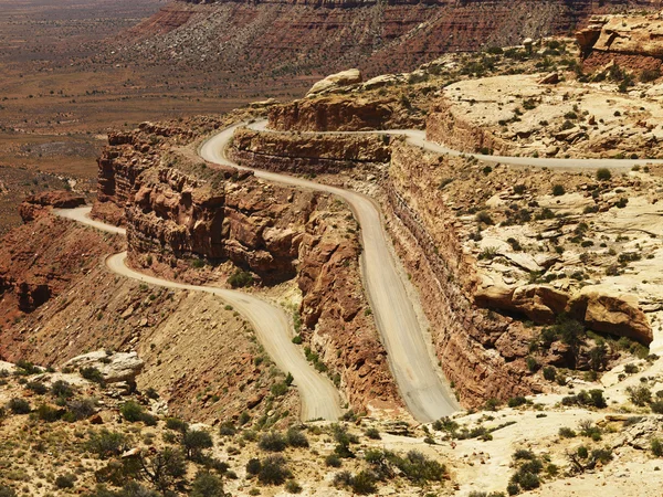 Kronkelende weg op ruwe woestijn rotsvorming — Stockfoto