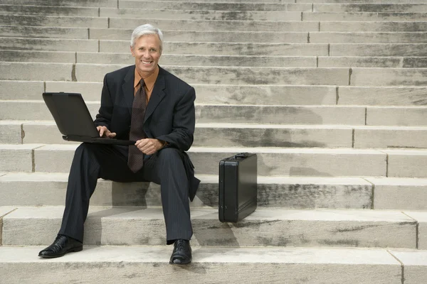 Businessman on steps. — Stock Photo, Image