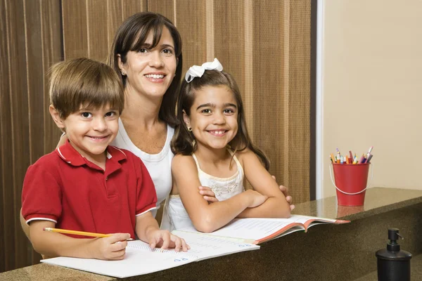 Anne ve çocuklar ile ev ödevi. — Stok fotoğraf