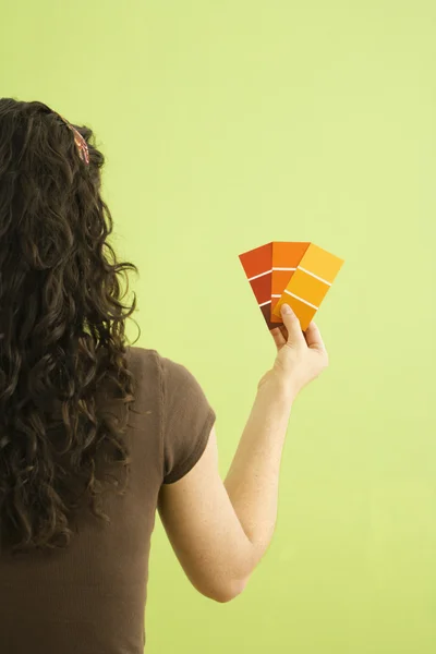 Woman with paint swatches. — Stock Photo, Image