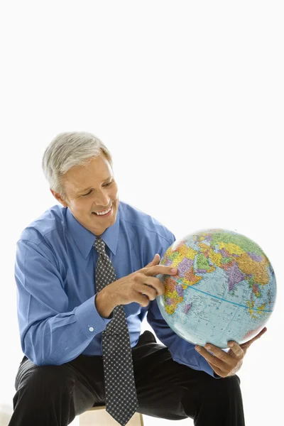 Homem apontando no globo . Fotos De Bancos De Imagens
