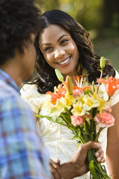 Woman getting flowers. Royalty Free Stock Images