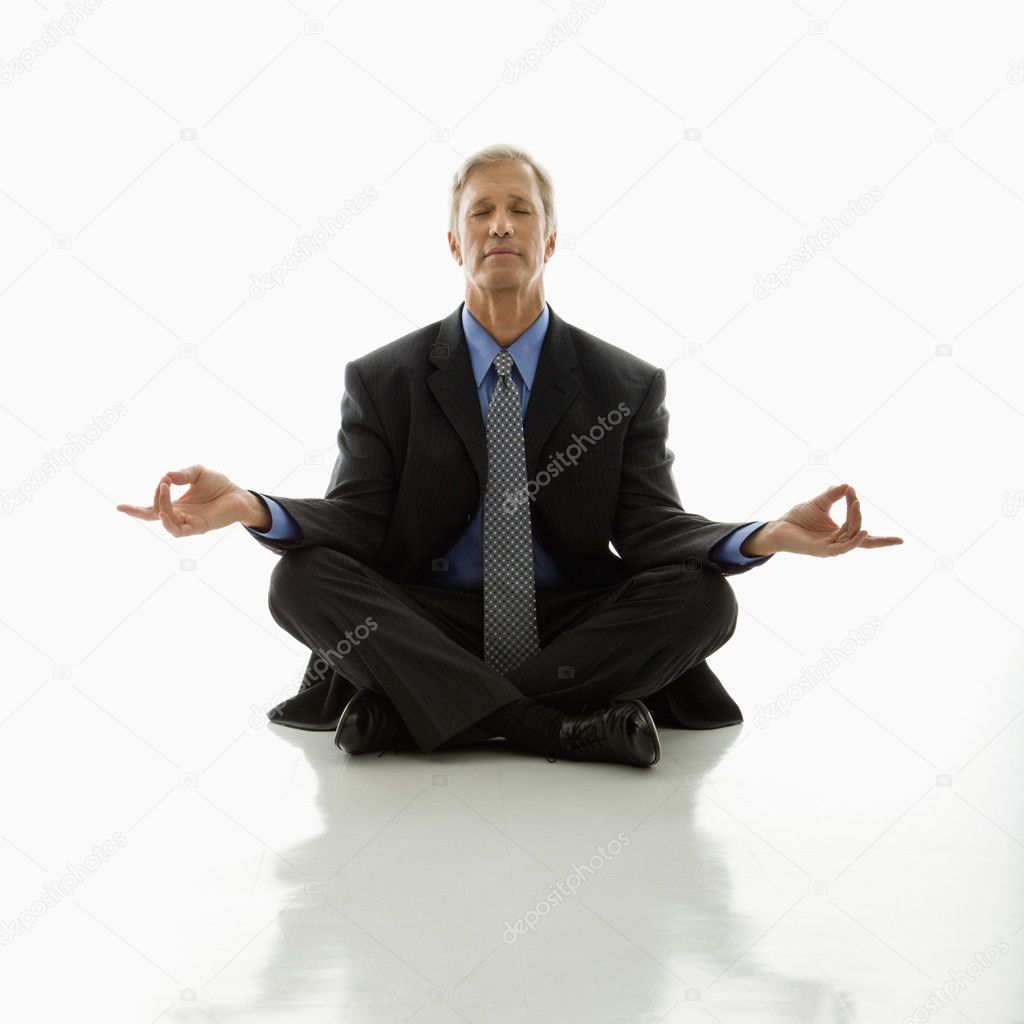 Businessman doing yoga.