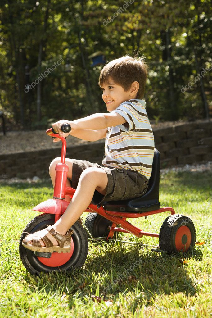 boy riding tricycle