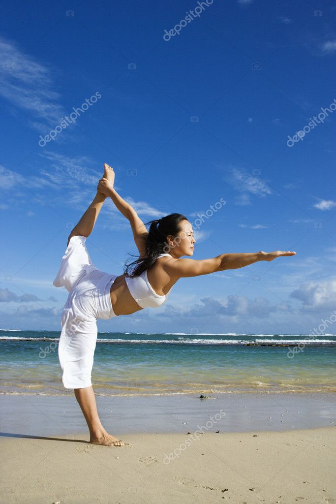 depositphotos 9306686 stock photo woman doing yoga on beach