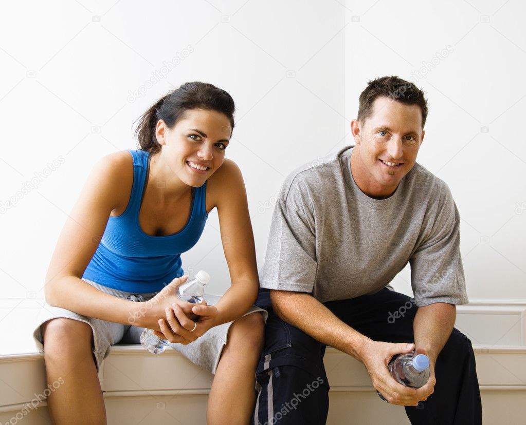 Male and female sitting smiling.