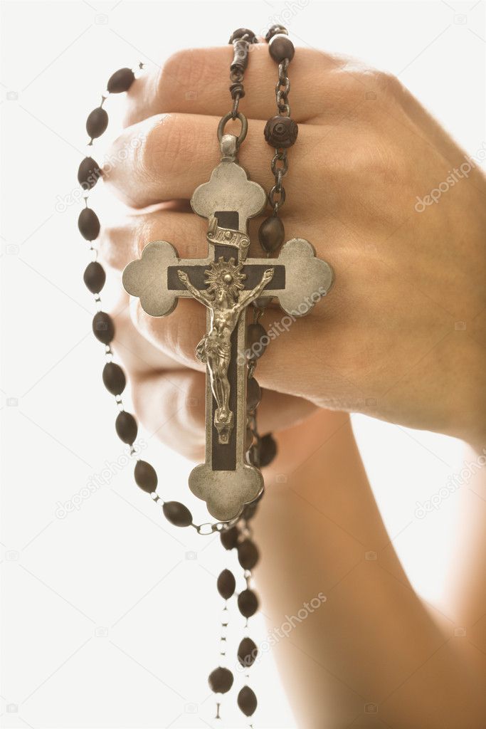 Woman holding crucifix.