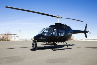 Helicopter parked at airport lot. clipart