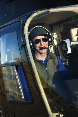 Male pilot in helicopter. clipart