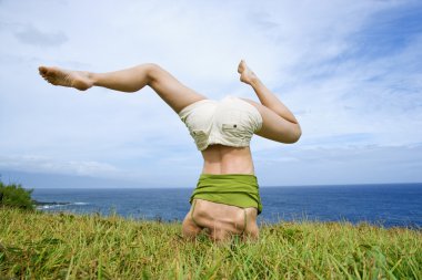 Woman doing headstand. clipart