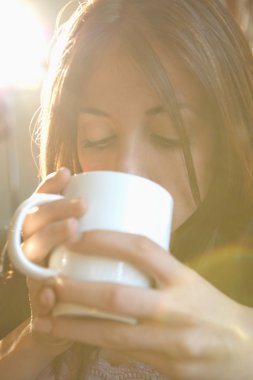 Woman drinking from mug