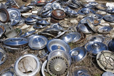 Old hubcaps on ground clipart