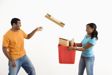 Man throwing cardboard into bin. clipart