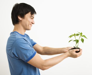 Man holding plant. clipart