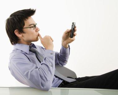 Man looking at cell phone. clipart