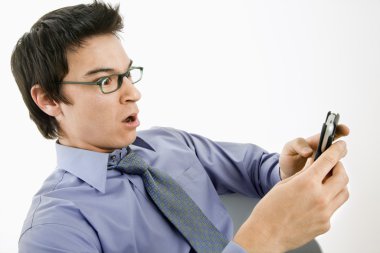 Man surprised at text message. clipart