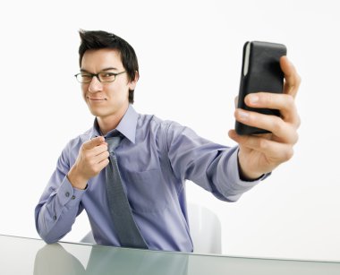 Man taking cell phone picture. clipart