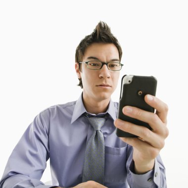 Businessman with cell phone. clipart