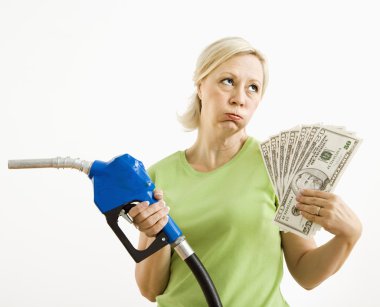 Unhappy woman with gas pump and money. clipart