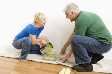 Man and woman pouring paint. clipart