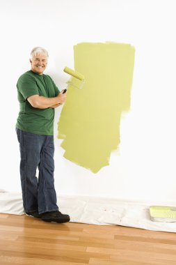 Man painting wall. clipart