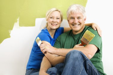 Man and woman relaxing while painting. clipart