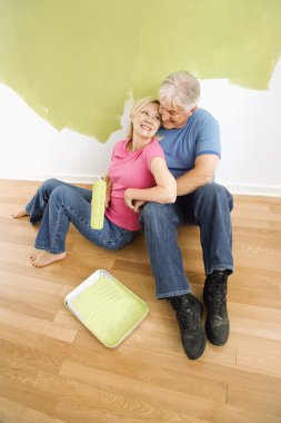 Happy couple with painting utensils. clipart