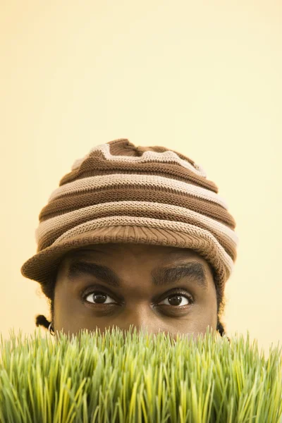 Homem escondido na grama . — Fotografia de Stock