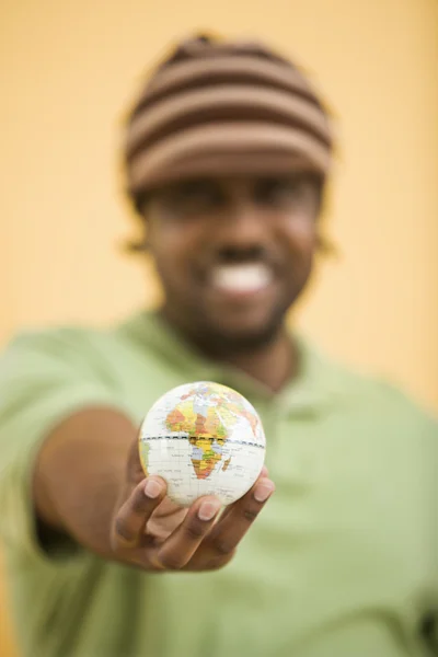 Man with small globe. — Stock Photo, Image