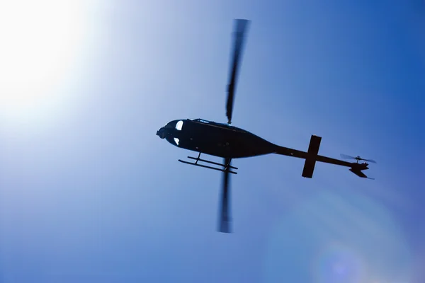 Stock image Black helicopter flying overhead.