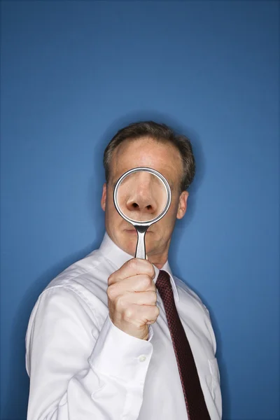 Businessman with magnifier — Stock Photo, Image