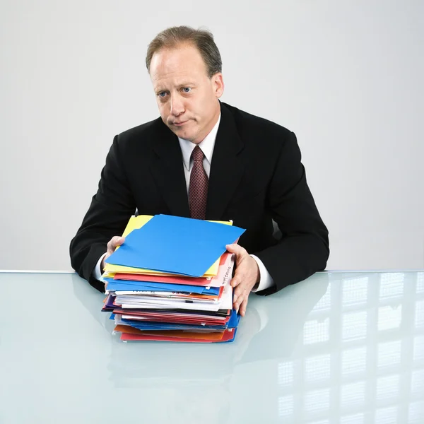 Businessman with workload — Stock Photo, Image