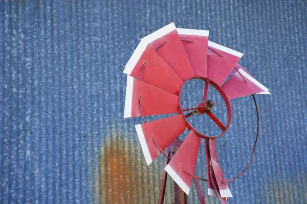 Broken windmill against blue background. — Stock Photo, Image