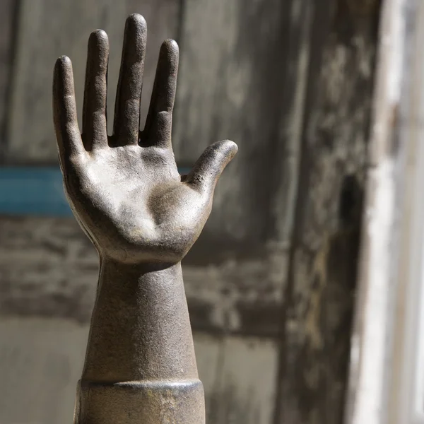 Old metal hand statuette.
