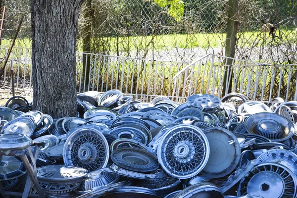 Piles of hubcaps on ground. — Stock Photo, Image