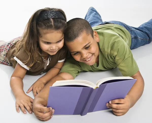 Brother and sister reading book together. — Stock Photo, Image
