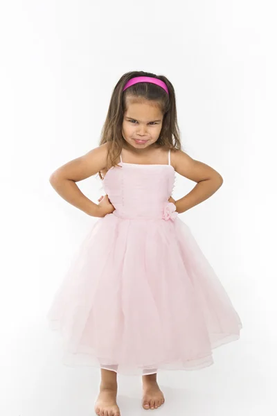 Little girl wearing pink dress pouting. — Stock Photo, Image