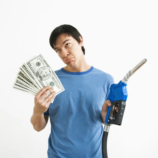 Man with money and gas nozzle. — Stock Photo, Image