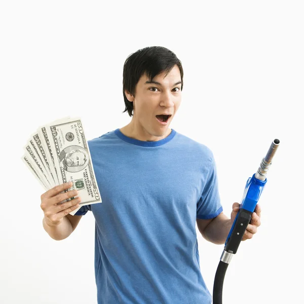 Man with money and gas nozzle. — Stock Photo, Image
