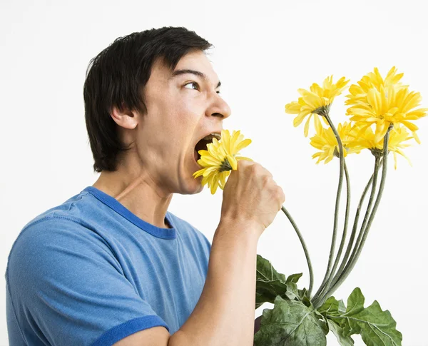 Man eating bouquet. — Stock Photo, Image