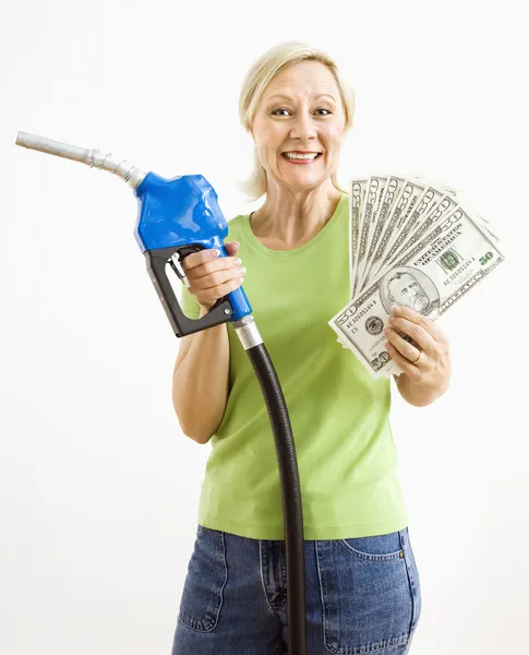 Mujer feliz con bomba de gasolina y dinero . Fotos de stock