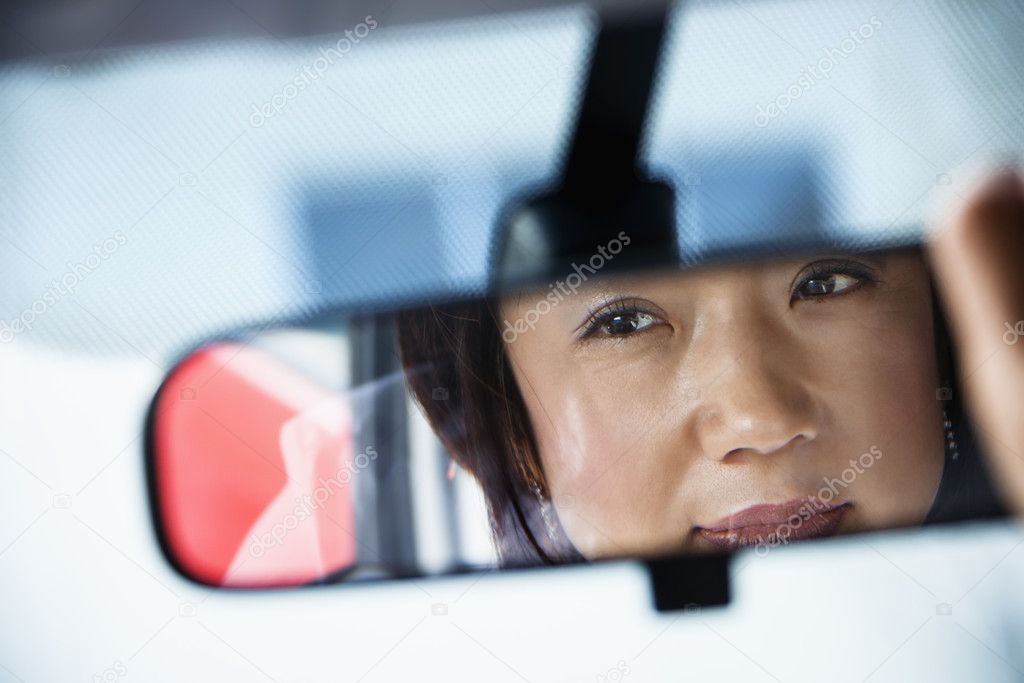 Woman in rearview mirror