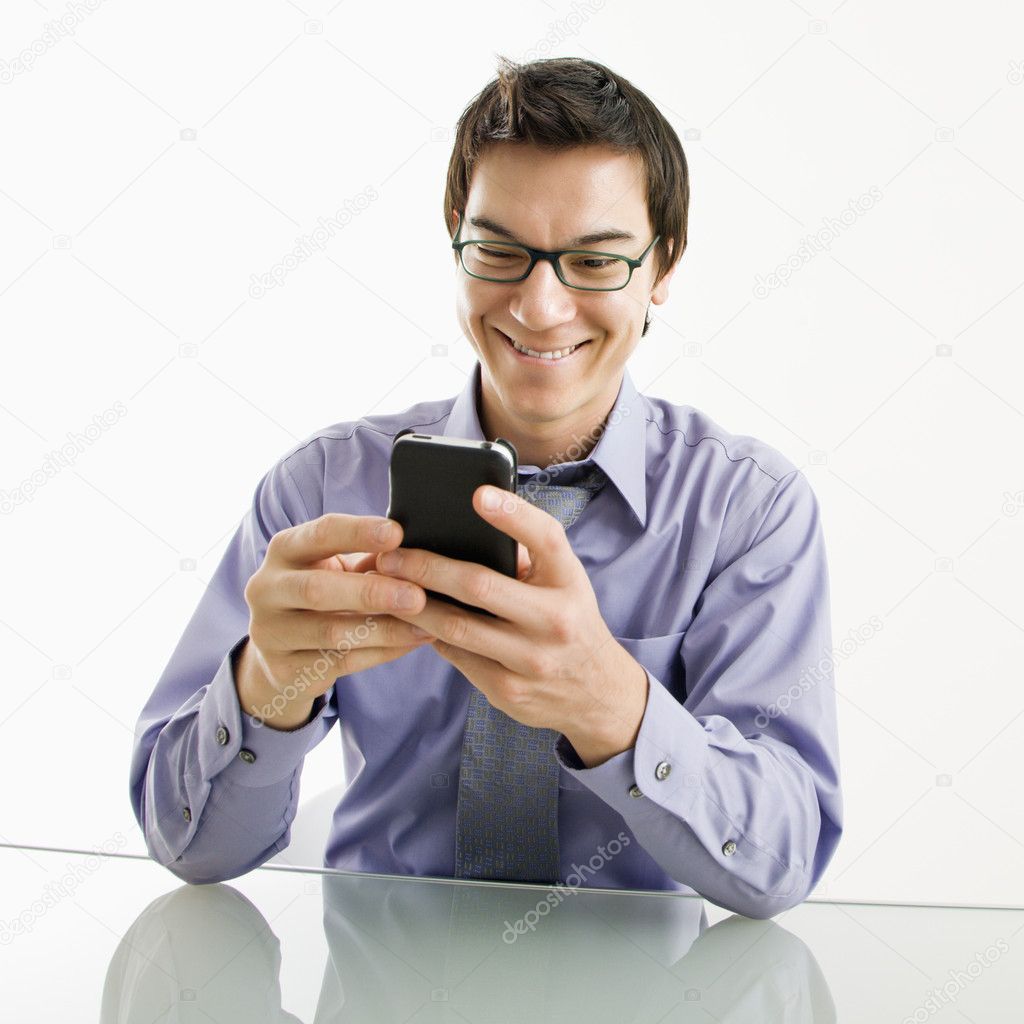 Smiling businessman on cell phone.