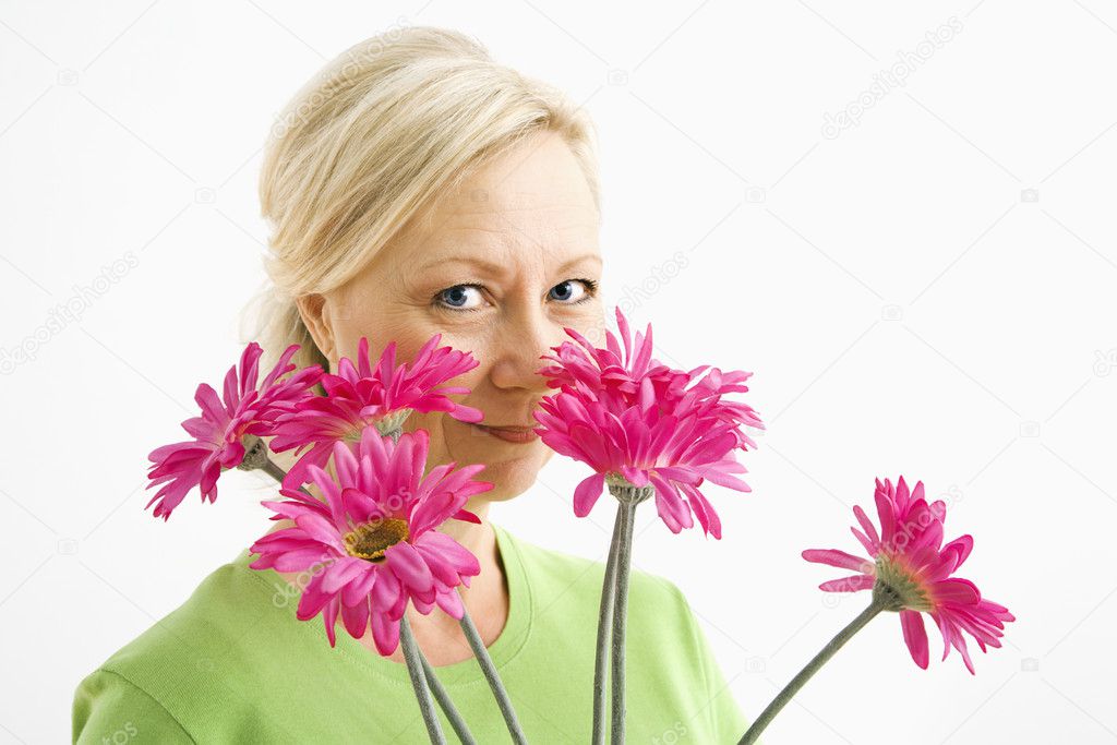 Woman looking over flowers.