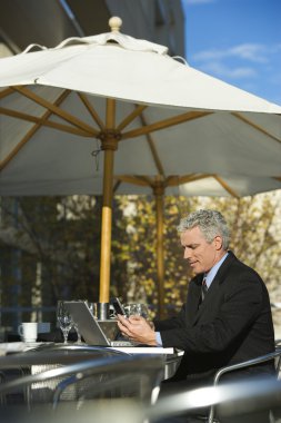 Businessman with laptop. clipart